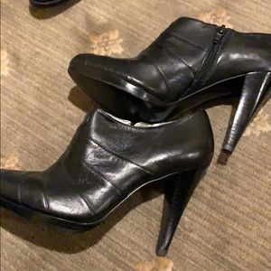 Black leather booties by Calvin Klein